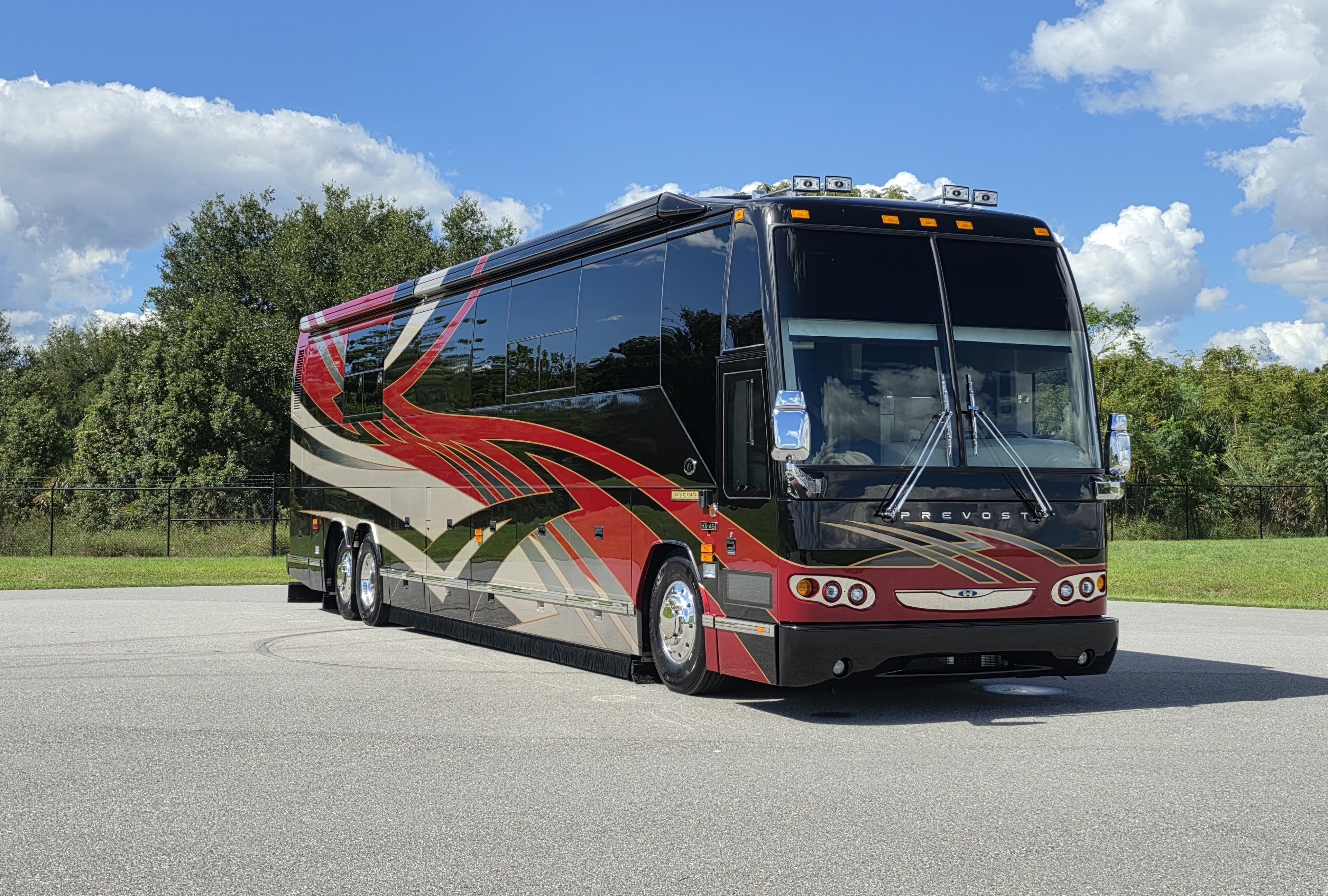 2003 Prevost, front three-quarter view, parked on pavement.